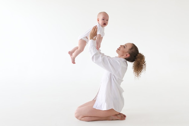 Mother and child Happy mother with six month old baby in her arms posing