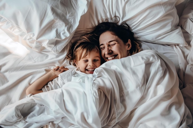 Mother and child sharing lighthearted moment of tickles and giggles on lazy Sunday morning in bed