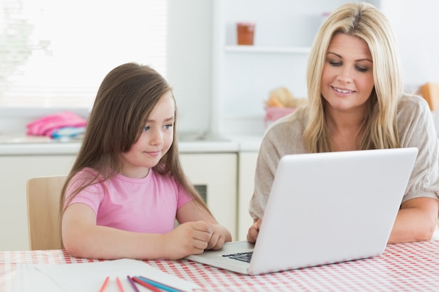 Mother and child sitting at the kitchen table