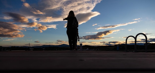 Mother and child and at sunset over mountain range white clouds banner wallpaper