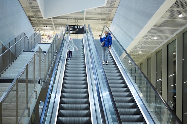 Mother and child together on escalator background Terminal airport travel love care