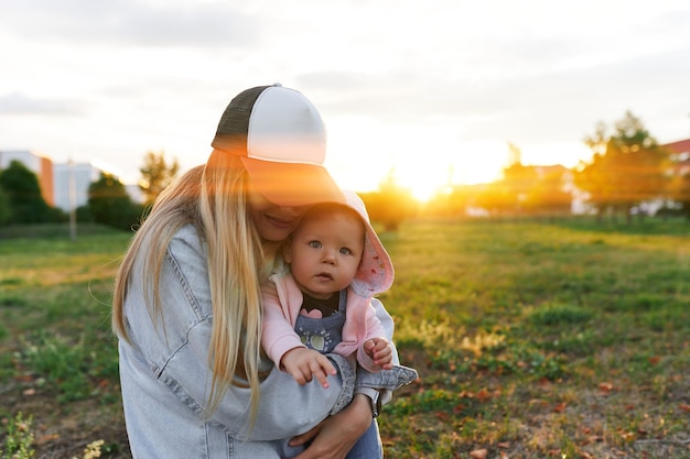 Mother and child walk in the park in the evening