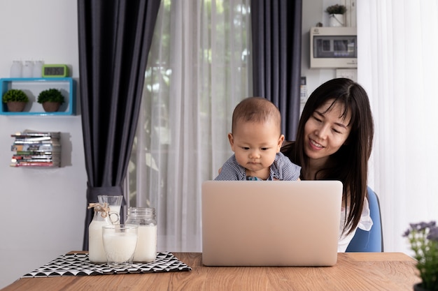 mother and children using laptop at home.