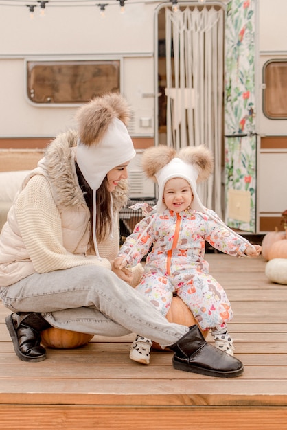 Mother and daugher playing near the trailer