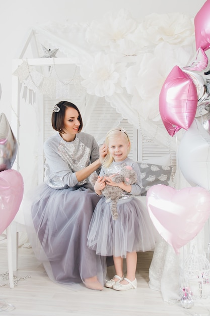 Mother and daughter in beautiful outfits 