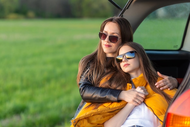 Mother and daughter camping on a hill