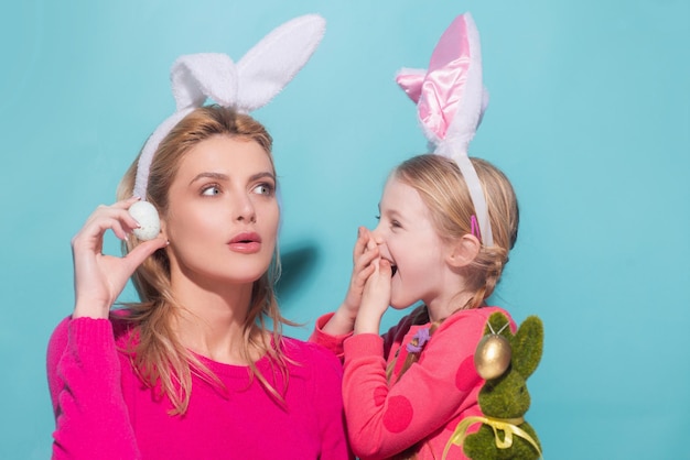 Mother and daughter celebrating easter child and mom in bunny ears laughing smiling and having fun