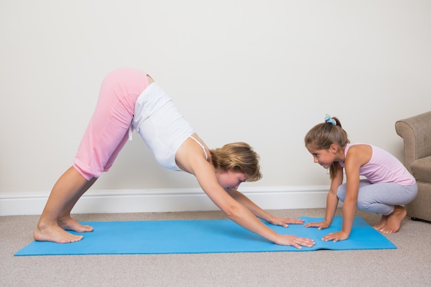 Mother and daughter doing yoga 