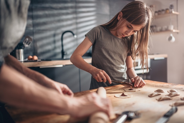 Mother and daughter filling ravioli with chocolate cream