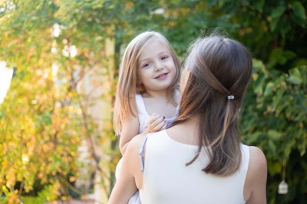 Mother and daughter in garden in summer