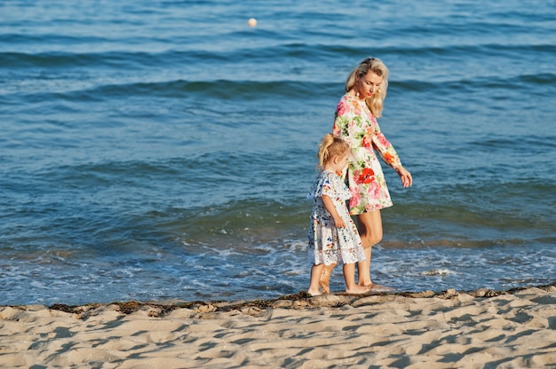 Mother and daughter having fun on the beach