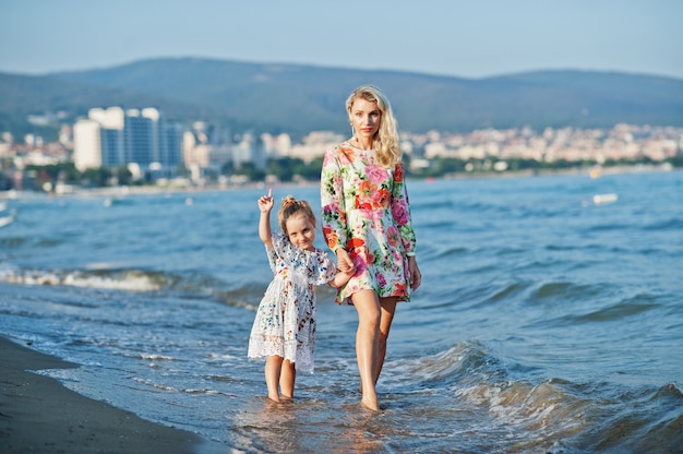 Mother and daughter having fun on the beach