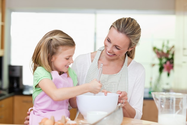 Mother and daughter having fun in the kitchen