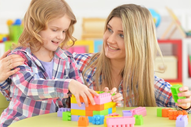 Mother and daughter having fun playing