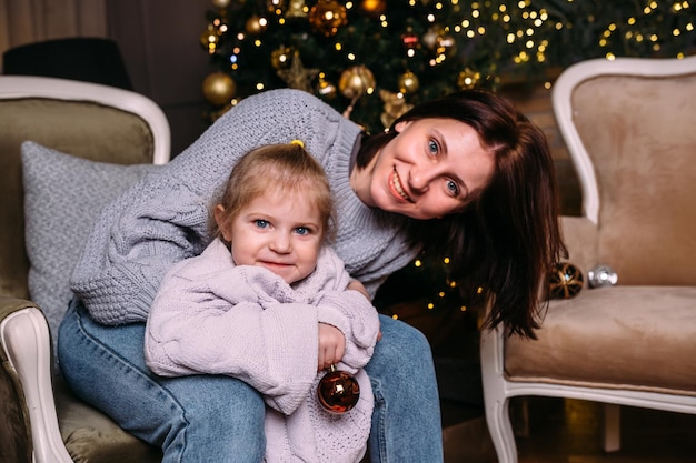 Mother and daughter having fun and relaxing at home Xmas and New Year concept