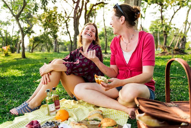 Mother and daughter having a picninc in the park