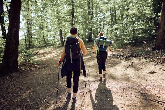 Mother And Daughter Hiking In The Forest