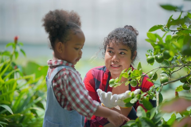 Mother and daughter making outdoor activities at garden diverse family happy motherhood weekend together with kid Mother's day concept