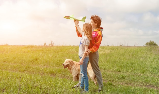 Mother and daughter playing with toy plane