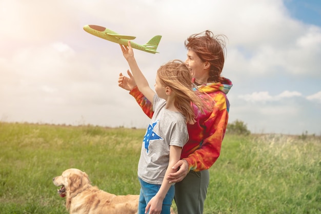 Mother and daughter playing with toy plane