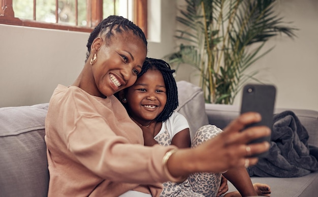 Mother and daughter selfies are always the best Cropped shot of an adorable mother and daughter taking selfies together at home