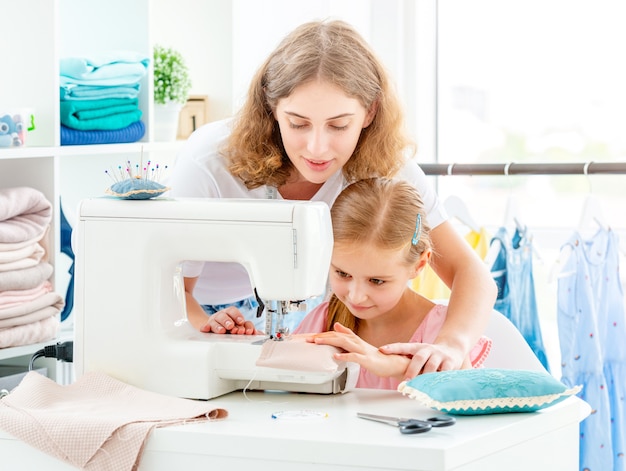 Mother and daughter sewing