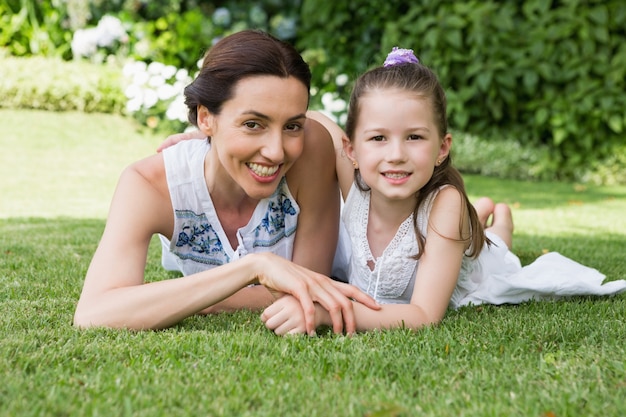 Mother and daughter smiling at camera