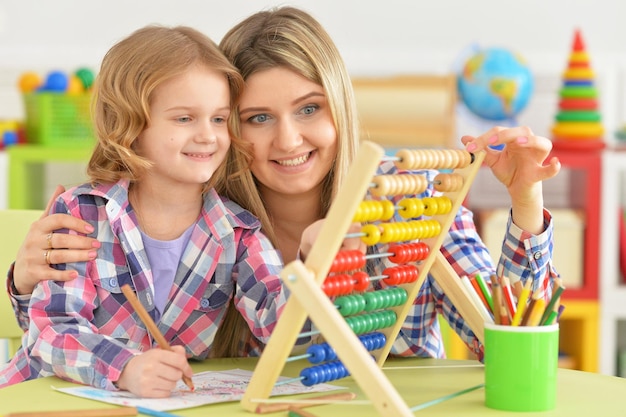 Mother and daughter study at the table