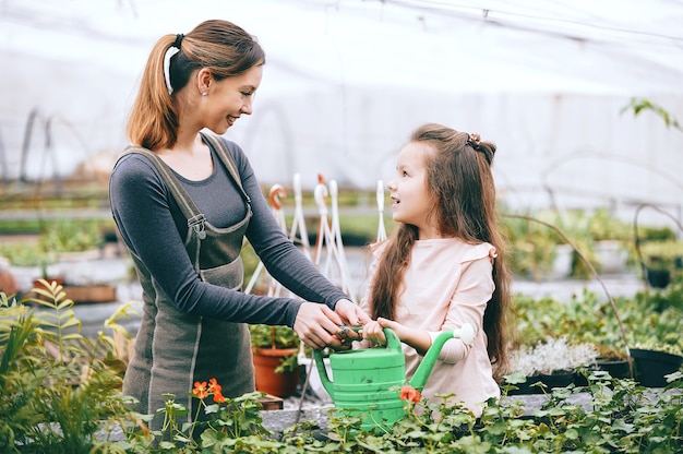 Mother and daughter taking care of plants