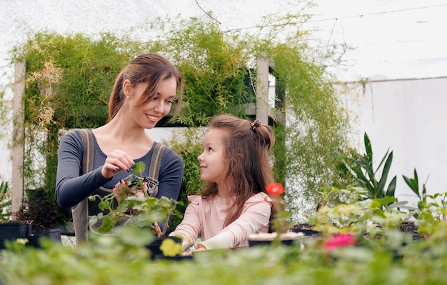 Mother and daughter taking care of plants