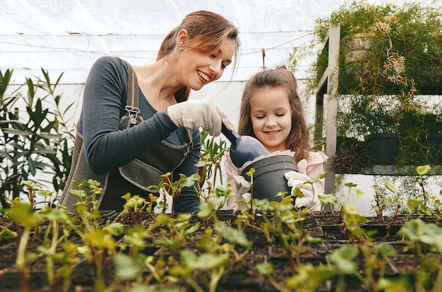 Mother and daughter taking care of plants