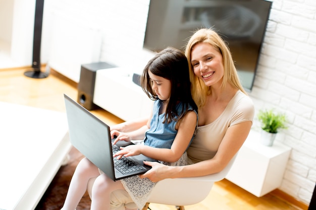 Mother and daughter together with laptop