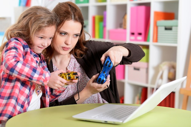 Mother and daughter using laptop together