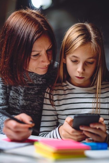 Mother and daughter using smart phone