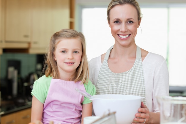 Mother and daughter with bowl in the kitchen