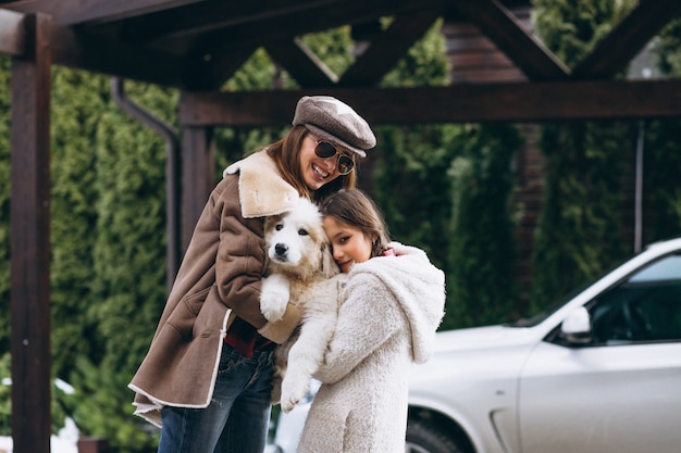 Mother and daughter with dog outside