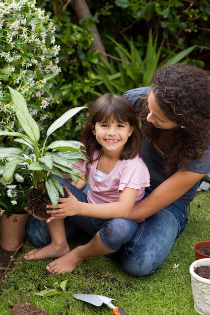 Mother and daughter working in the garden 