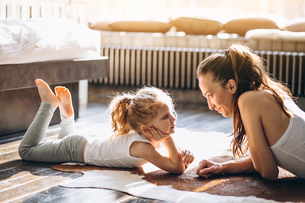 Mother and daughter yoga at home