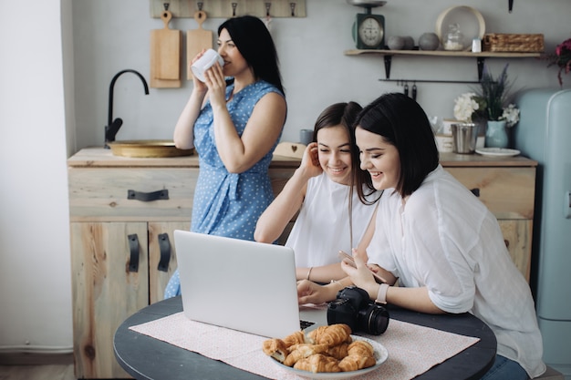 Mother and daughters having fun together in the kitchen