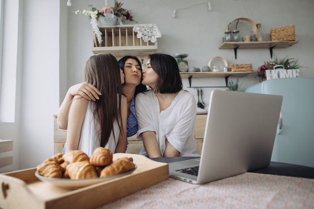 Mother and daughters talking in the kitchen