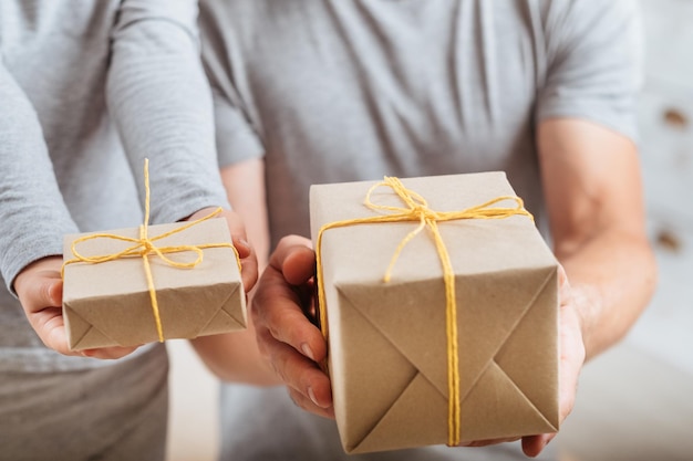 Mother day Loving little child and husband prepared gifts holding paper wrapped boxes