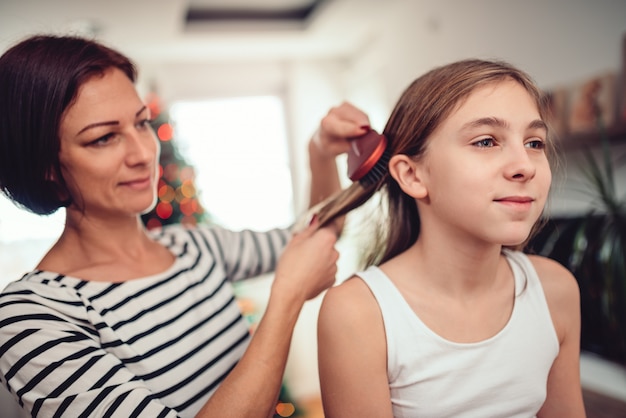 Mother drying hair to her daughter