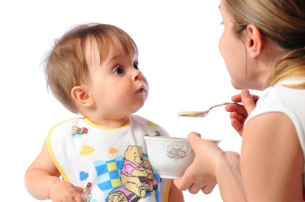 Mother feeding her little girl