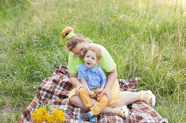 A mother gently hugs a disabled child. Infantile cerebral palsy. Enabling. Disability. A family with a disabled child.