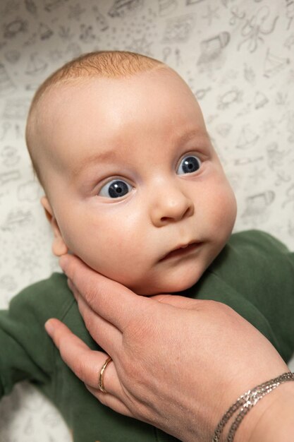 mother gently touches the baby's face