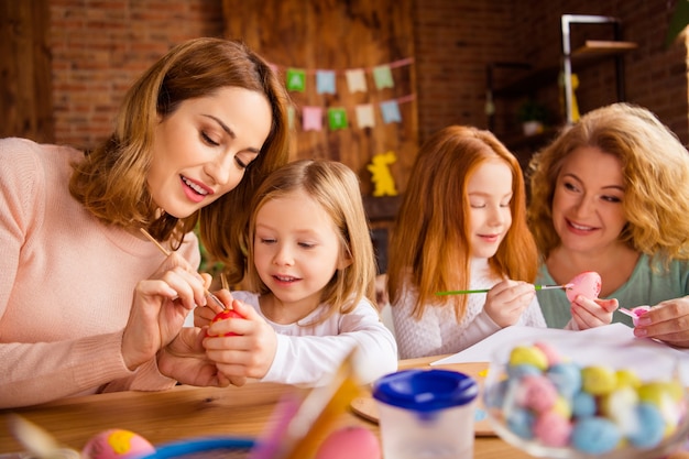 mother and grandmother with children painting