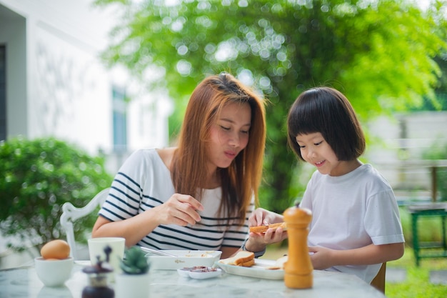 Mother have breakfast with her children family timexA