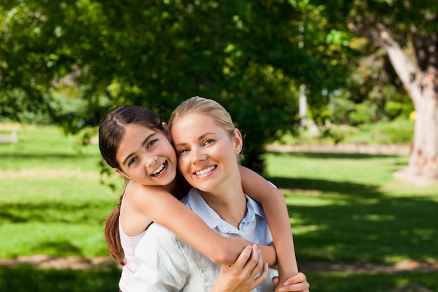 Mother having daughter a piggyback