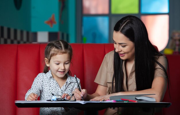 Mother helping her daughter with homework