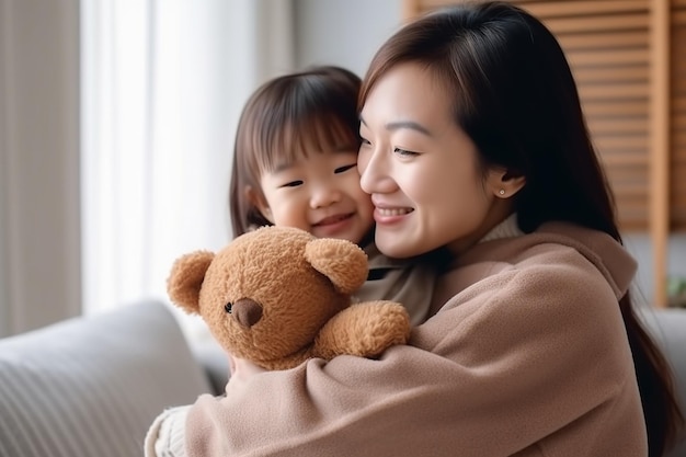 A mother and her child are holding a teddy bear.